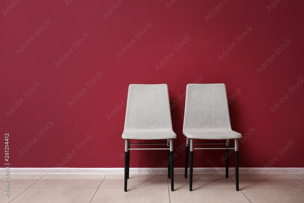 Chairs near color wall