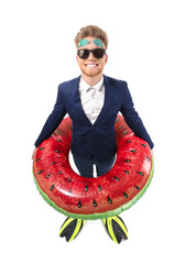 Sticker - Funny young tourist in suit and with inflatable ring and flippers on white background