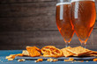 A selection of beer and snacks on wooden background