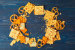 Scattered beer snacks assortment on blue wooden background
