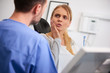 © gpointstudio - Woman with toothache talking to dentist
