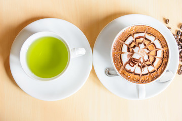 hot cappuccino on wood table /hot cappuccino with coffee bean 