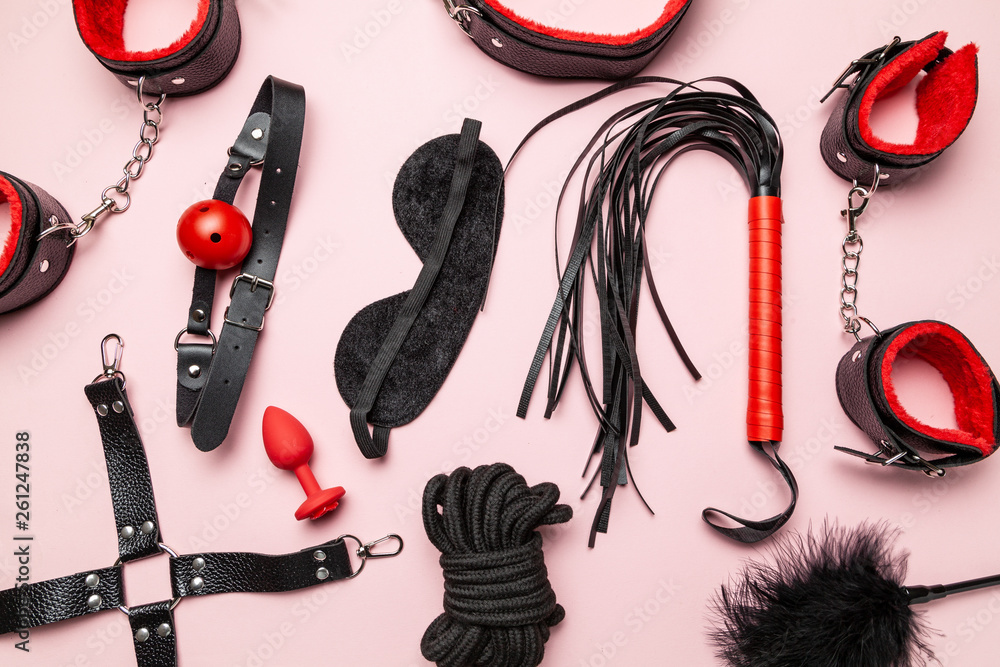 Set of erotic toys for BDSM. The game of sexual slavery with a whip, gag and leather blindfold. Intimate sex games. - obrazy, fototapety, plakaty 