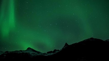 northern light (aurora borealis) over a snowy mountain 4k