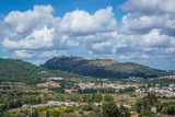 Fototapeta Miasto - Distance view of Castelo de Palmela on a hill seen from Setubal city, Portugal