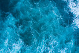 Fototapeta Łazienka - Top view of blue frothy sea surface. Shot in the open sea from above.