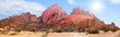 © Vera Shestak - Spitzkoppe mountains range panoramic view on blue sky, clouds and bright sun background, red mountain rocks panorama landscape in Namibia, Southern Africa, beautiful tourist banner design, copy space