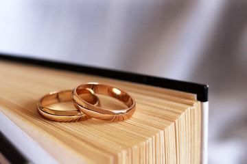 Two wedding rings and a book so close