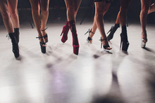 Young Striptease Dancer Moving In High Heels Shoes On Stage In Strip Night Club, Pole Dancing.