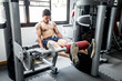 © 220 Selfmade studio - Asian handsome Man workout with Leg Extensions for builder muscle in upper leg exercise in gym feeling so strong and powerful,Bodybuilder Concept