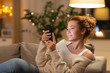 © Syda Productions - technology and people concept - happy young woman with smartphone at home in evening