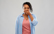 emotion, expression and people concept - shocked african american woman over grey background