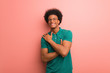 © Asier - Young african american man over a pink wall giving a hug