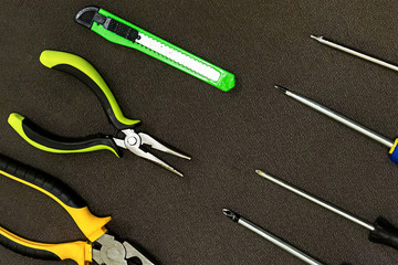 row of tools rubber nippers green knife building metal screwdriver pattern building