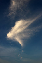 Cloudscape Background Of Fine Wispy Cloud In A Funnel Shape Against Blue Sky