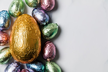 Wall Mural - Easter egg chocolate treats wrapped in shiny coloured foil