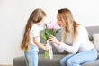 © Evrymmnt - Cute little five year old girl giving her mom a present for mothers day. Adorable scene with daughter surprizing her mum. Close up, background, portrait.