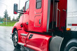© vit - Red big rig semi truck with semi trailer running on the wet road in rain weather