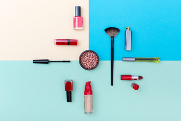 Decorative cosmetics, makeup products and brushes on pastel blue color background