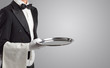 © ra2 studio - Waiter serving with white gloves and steel tray in an empty space