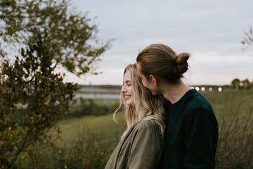 Romantic and Loving Young Adult Couple at the Park Looking At Nature and the Horizon for Portrait Pictures