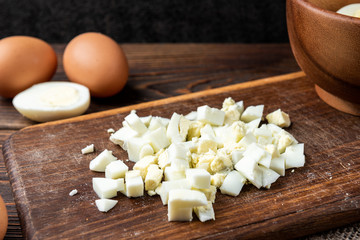 Wall Mural - Boiled eggs on dark wooden background.