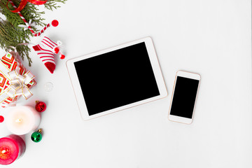 stylish tablet and smart phone mockups for christmas time, pine cones and tree branches on white background, christmas decorations and celebrations