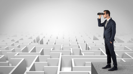 Wall Mural - businessman standing on maze and looking forward to the future concept