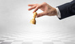 © ra2 studio - Big elegant hand taking his next step on chess game