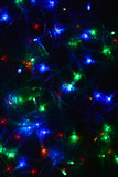 Fototapeta Pokój dzieciecy - Colored lights (garland) in the dark. Bokeh effect Festive illumination.