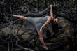 © Macia Puiggros/ADDICTIVE STOCK - Young ballerina in grey wear with stretched out leg posing on branches of dry woods