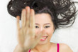 © Nutt - asian women  lying on ground with black long hair. acting smile, happy, and showing stop gesture.