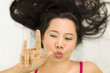 © Nutt - Closeup portrait of happy asian women  lying on ground with black long hair. acting smile, fun,