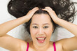 © Nutt - Closeup portrait of happy asian women  lying on ground with black long hair. acting smile, fun,