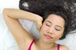 © Nutt - Closeup portrait of happy asian women  lying on ground with black long hair. acting smile, fun,