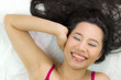 © Nutt - Closeup portrait of happy asian women  lying on ground with black long hair. acting smile, fun,