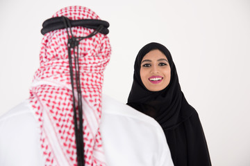 Wall Mural - arab couple smiling and standing on white background