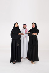 Canvas Print - Two arab females with one male smiling and standing on white background