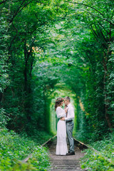 the couple in love stand face to face on railway track. beautifu