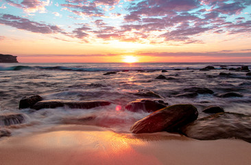 Wall Mural - Sunrise at Bronte Beach, New South Wales, Australia. Waves on the rocks.