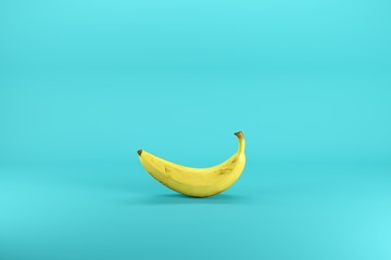 Wall Mural - Single ripe yellow banana isolated on blue background. Minimal fruit idea concept.