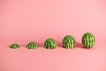 Slices Of Fresh Watermelon On Pink Background. Minimal Fruit Idea Concept.