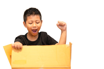 Boy surprised by opening parcel box isolated in clipping path.