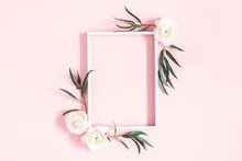 Flowers Composition. White Flowers, Eucalyptus Leaves, Photo Frame On Pastel Pink Background. Flat Lay, Top View, Copy Space
