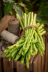 Wall Mural - Tasty and fresh green asparagus on wooden box