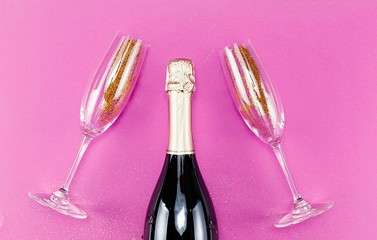 Wall Mural - Champagne glasses with splash of golden confetti. Top view. Cele