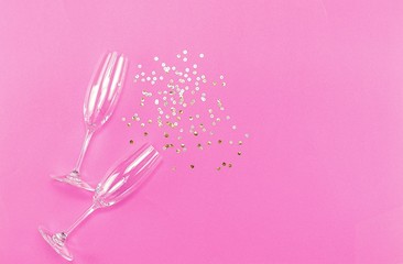 Wall Mural - Champagne glasses with splash of golden confetti. Top view. Cele