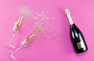 Wall Mural - Champagne glasses with splash of golden confetti. Top view. Cele