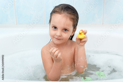 Close Up Portrait Of Happy Charming Little Girl Sitting In