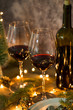 Red wine on table with Christmas lights on the background